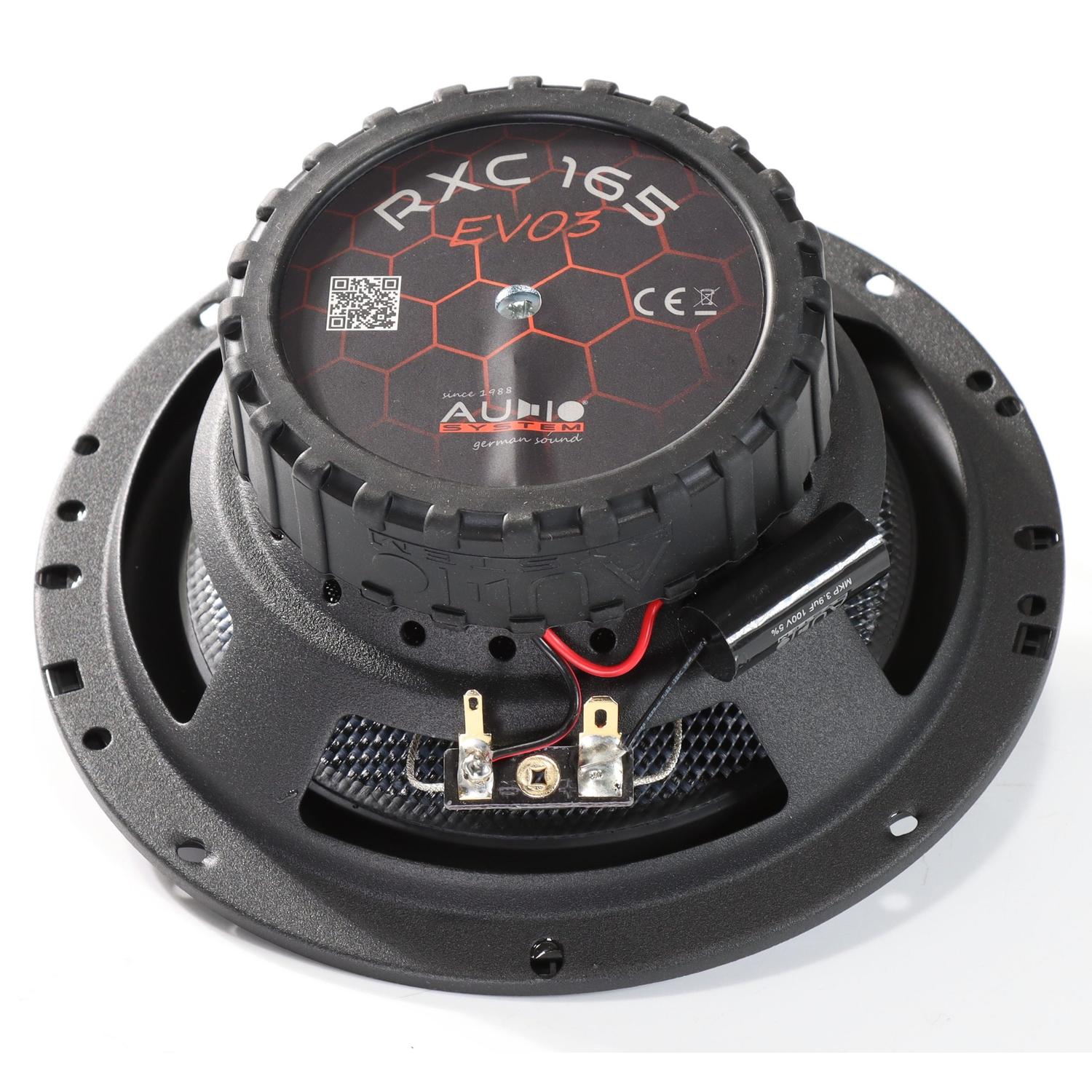 A black Audio System RXC165 EVO3 165mm car speaker features a red hexagon design, metal frame, and exposed wiring terminals at the bottom.