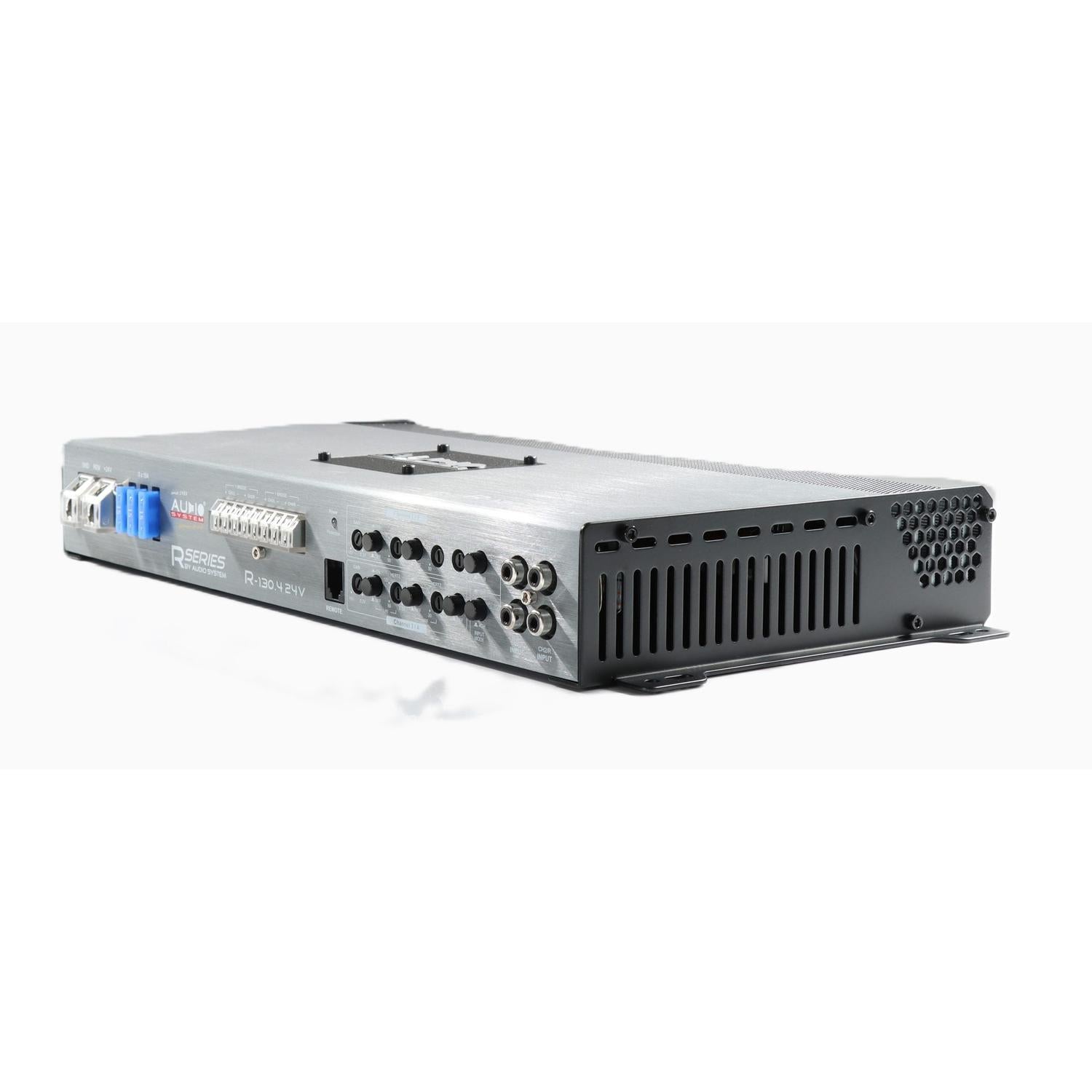 The Audio System R-130.4 24V is a silver and black 4-channel car amplifier with multiple ports, vented sides, and labeled connections, shown on a white background.