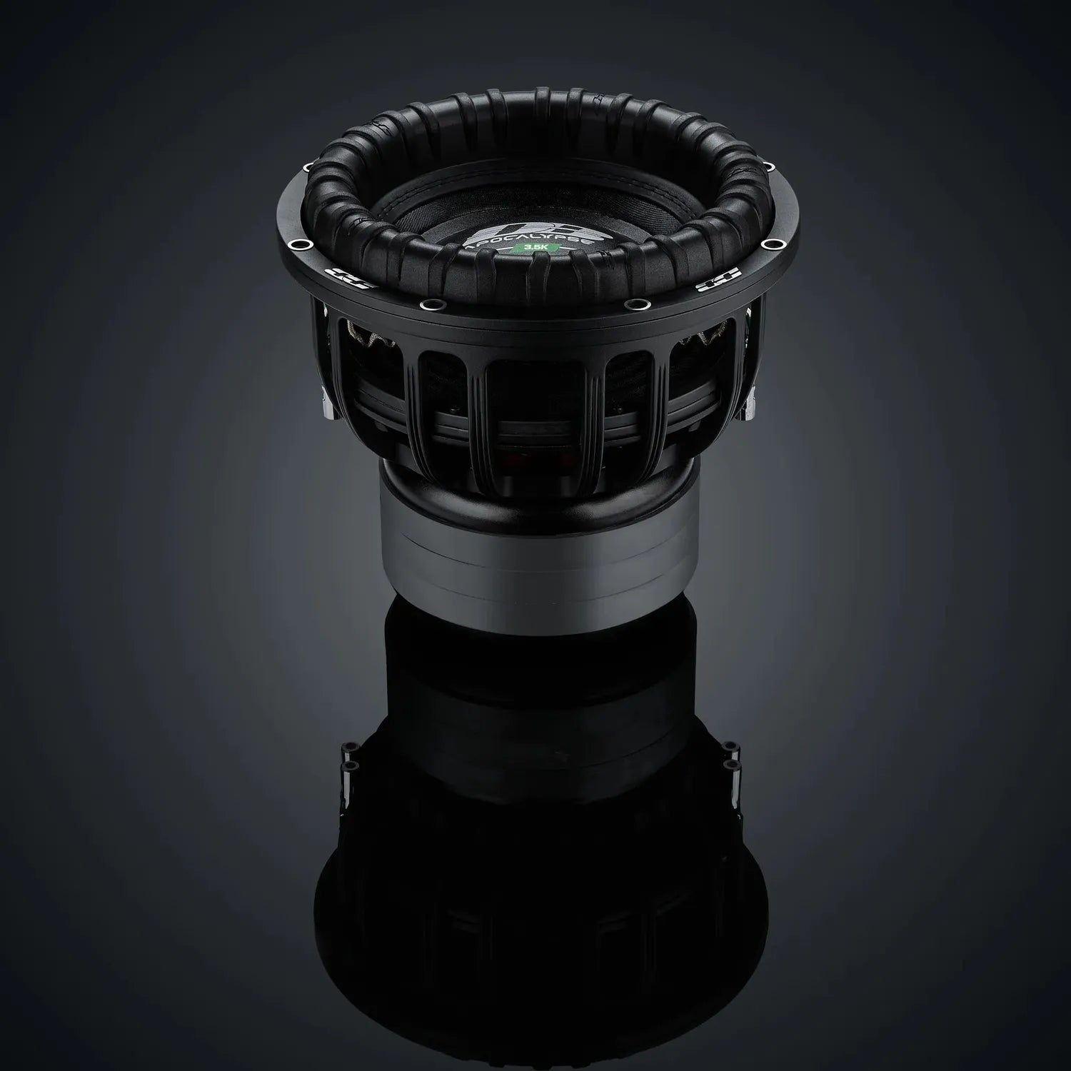 The Deaf Bonce Apocalypse DВ-3.5K 12 subwoofer features a ribbed cone and metal frame, shown against a dark reflective surface with a gradient background.