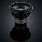 El subwoofer Deaf Bonce Apocalypse DВ-3.5K de 15, con un gran cono y un pesado envolvente, entrega 3500W RMS y se muestra sobre una superficie reflectante contra un fondo oscuro.