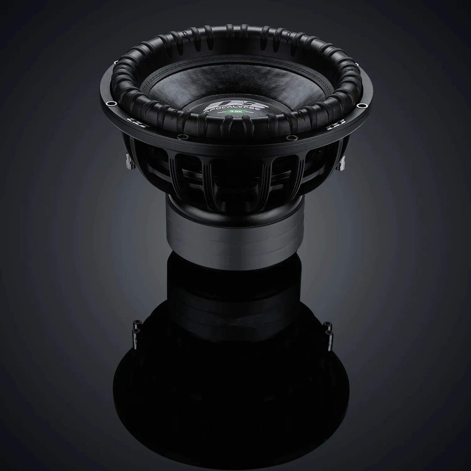El subwoofer Deaf Bonce Apocalypse DВ-3.5K de 15, con un gran cono y un pesado envolvente, entrega 3500W RMS y se muestra sobre una superficie reflectante contra un fondo oscuro.