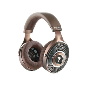 Los auriculares Focal Clear Mg open-back de color bronce presentan almohadillas y rejilla perforadas sobre un fondo blanco.