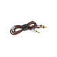 Un cable de audio marrón en espiral con conectores plateados y puntas chapadas en oro para Focal Stellia, sujeto por una correa de velcro negra.