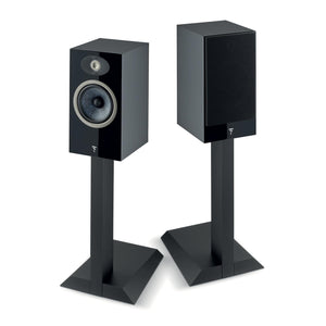 Two black Focal Theva N°1 bookshelf speakers on stands: one with its grille off to show the drivers, the other with the grille attached.