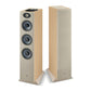 Due diffusori a 3 vie Focal Theva N°3-D alti e rettangolari in legno chiaro; uno rivela tre altoparlanti, laltro ha una griglia beige. Ideali per qualsiasi configurazione home theater.
