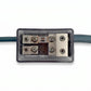 Close-up of a Four Connect 4-600422 2x50mm²/2x25mm² Mini-ANL fuse holder with transparent cover, showing terminals, fuse inside, and blue cable on white background.