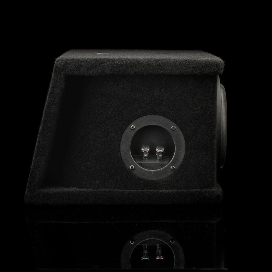 Un subwoofer con caja Gladen Sigma SSW065 Dual, con terminales para cables de altavoz, mostrado sobre un fondo negro con un sutil reflejo en la parte inferior.