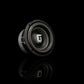 Un subwoofer Gladen Sigma SSW065 nero con il logo al centro, raffigurato su uno sfondo nero con un leggero riflesso nella parte inferiore.