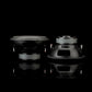 Dos subwoofers Gladen Sigma SSW10 están colocados uno al lado del otro sobre una superficie reflectante, uno en posición vertical y otro con la parte trasera a la vista, sobre un fondo negro liso.