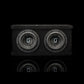 Una caja de subwoofer doble Gladen Sigma SSWX065, de color negro y forma rectangular, con dos altavoces de 6,5, reflejados en una superficie brillante.