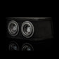 El Gladen Sigma SSWX065 Dual es un subwoofer rectangular negro con dos altavoces de 6,5, que aparece en una imagen sobre un fondo negro con su reflejo debajo.