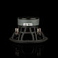 Un subwoofer Gladen Zeta 10, nei colori nero e argento, è appoggiato su una superficie nera; presenta unetichetta con codice a barre e dei terminali di collegamento, ed è progettato per garantire prestazioni potenti nei bassi.