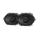 Zwei schwarze, ovale JBL STAGE3 868F-Autolautsprecher mit gemusterter Oberfläche und einem Kreis in der Mitte, nebeneinander auf weißem Hintergrund.