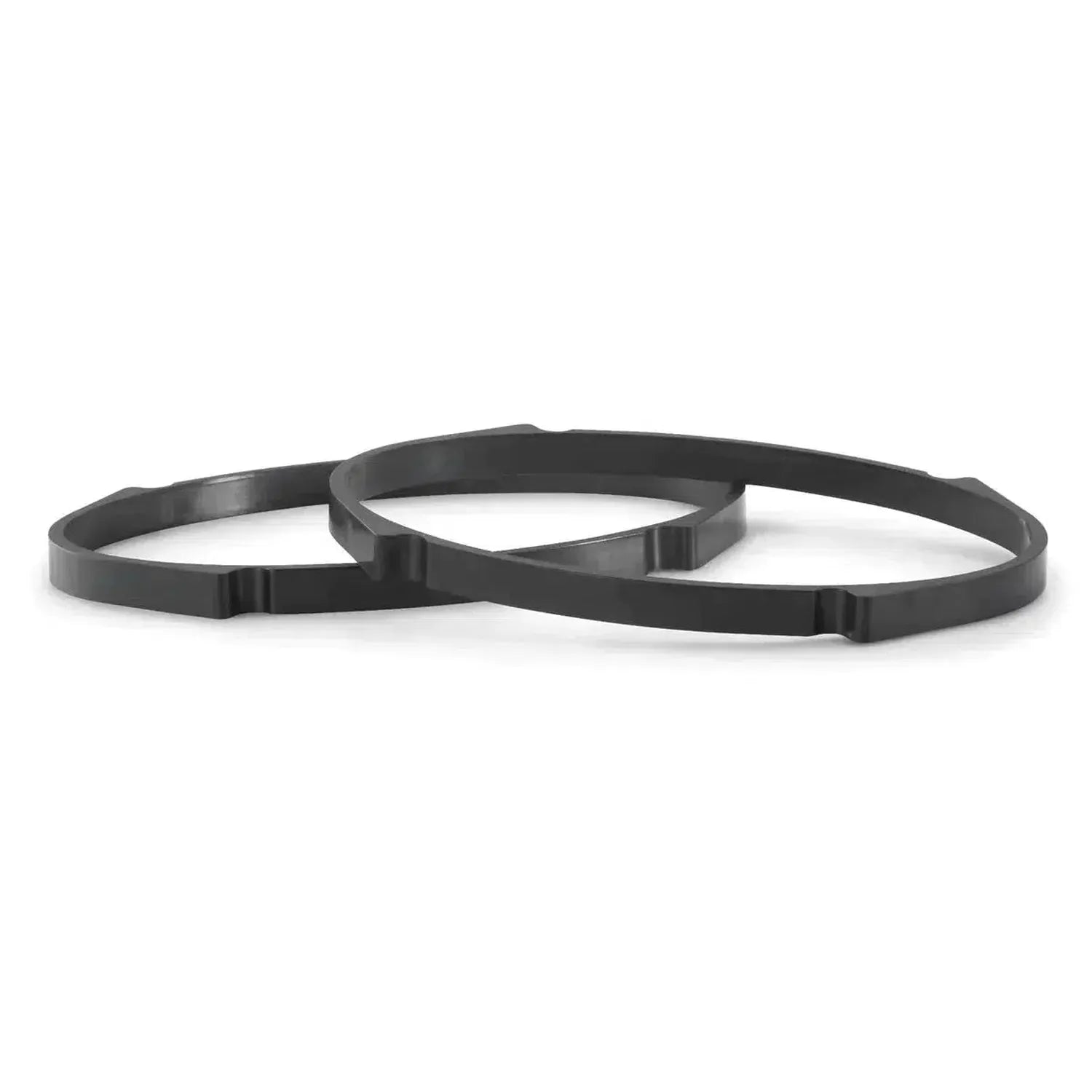 Two black, circular plastic rings with notched edges, similar to JL Audios C1-570X speakers, overlap on a white background.