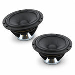 Two black and silver Scanspeak Illuminator 18WU/8741T00 speakers with Tiefmitteltöner rest on a white surface, angled to show their round cones and mounting rims.