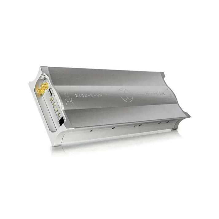 The Xcelsus Magnifico 1 is a sleek, metallic rectangular device with Class-D technology, showing a small circuit board and connector on one end against a white background.