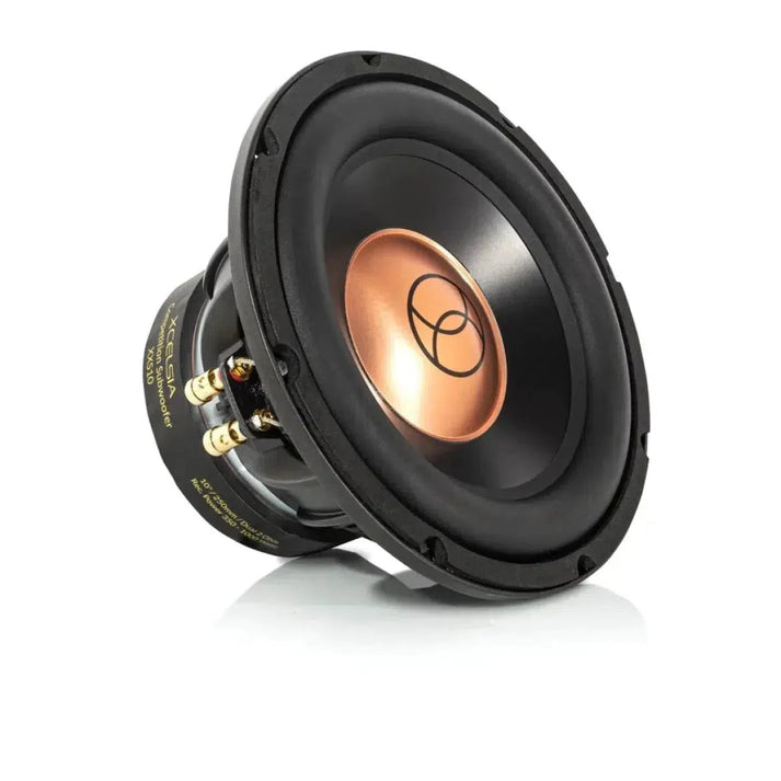A black and copper Xcelsus Xcelsia Competition XXS10 10-inch subwoofer with gold connectors, 700W power, shown angled to display front and side on a white background.